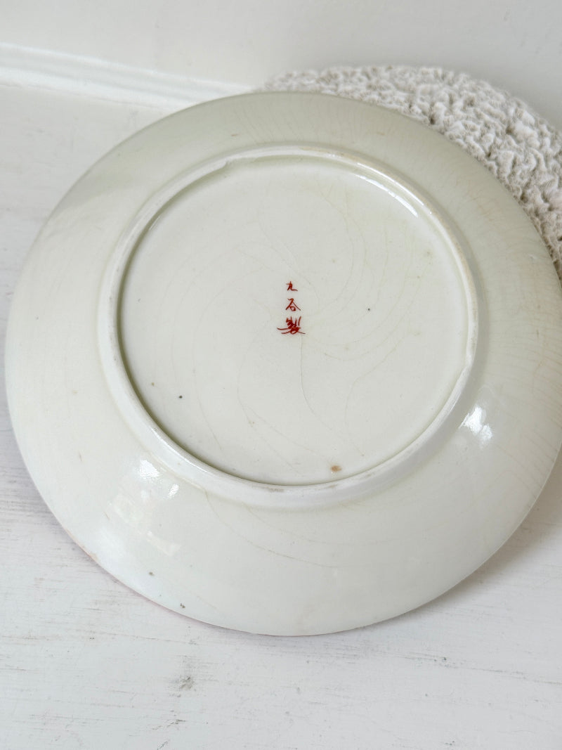 Japanese Kutani porcelain dish hand painted with a garden pavilion scene in iron red and gold