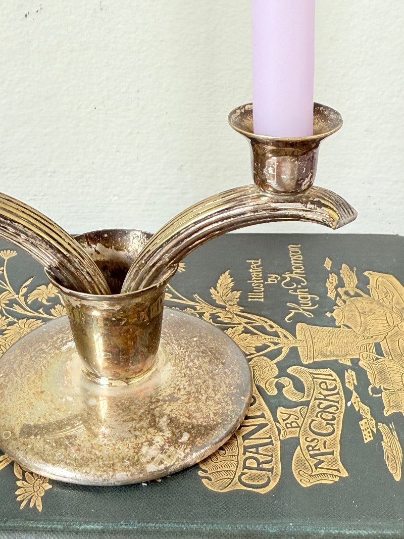 Vintage miniature silver plate candlestick with twin holders, photographed on white surface