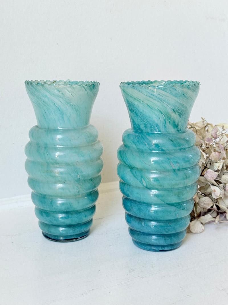 Pair of vintage aqua blue glass vases with beehive pattern and scalloped edges, photographed on a white surface