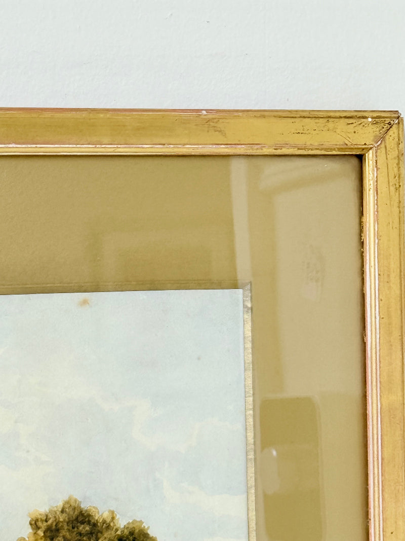 Antique watercolour landscape in gilt frame, countryside scene with trees, photographed on white surface.
