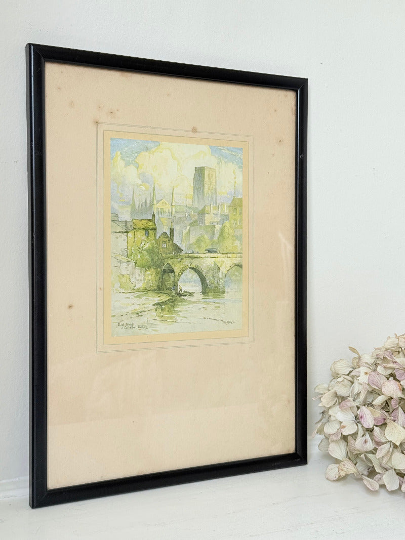 framed print of durham cathedral and elvet bridge with soft green and yellow tones photographed on white surface