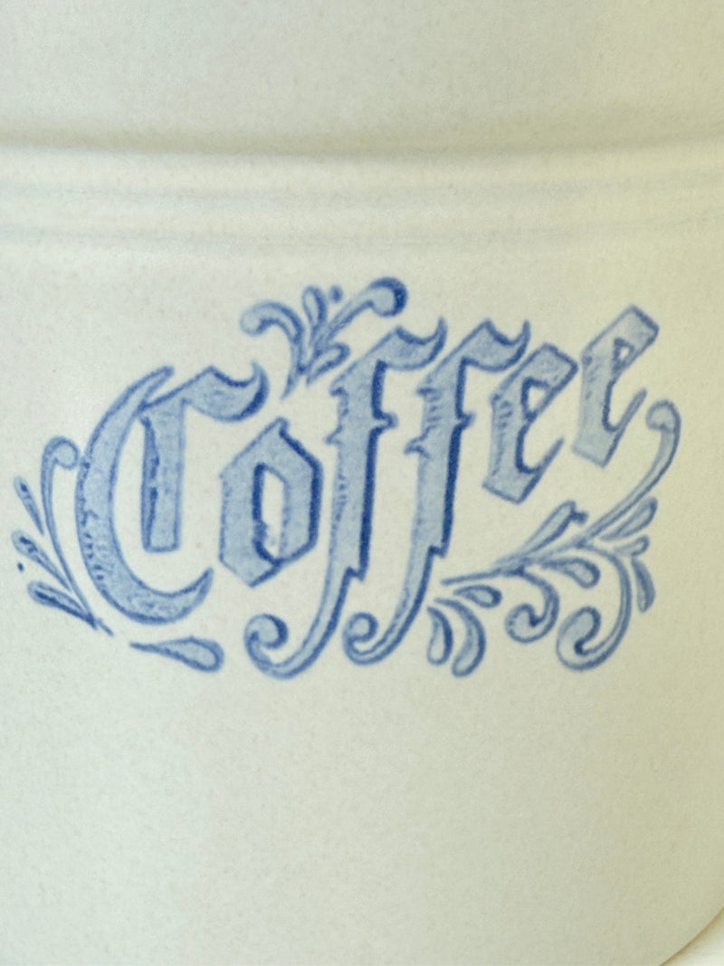 Pfaltzgraff Yorktowne stoneware coffee jar with blue floral motif and lid, photographed on a white surface