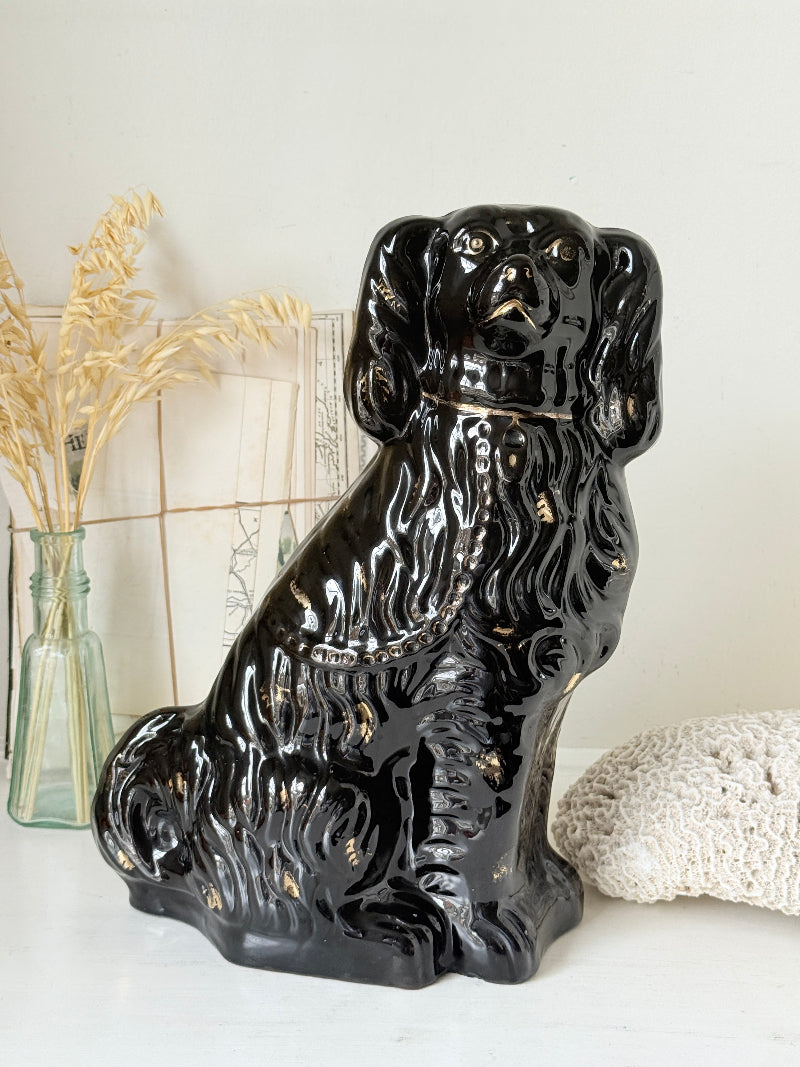 Vintage Staffordshire style black ceramic spaniel dog with gold lustre collar, glossy glaze and textured coat detail