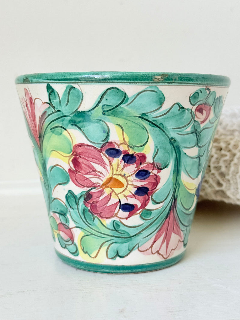 Italian handmade pot with colourful floral decoration, glazed finish, marked base, photographed on white surface.