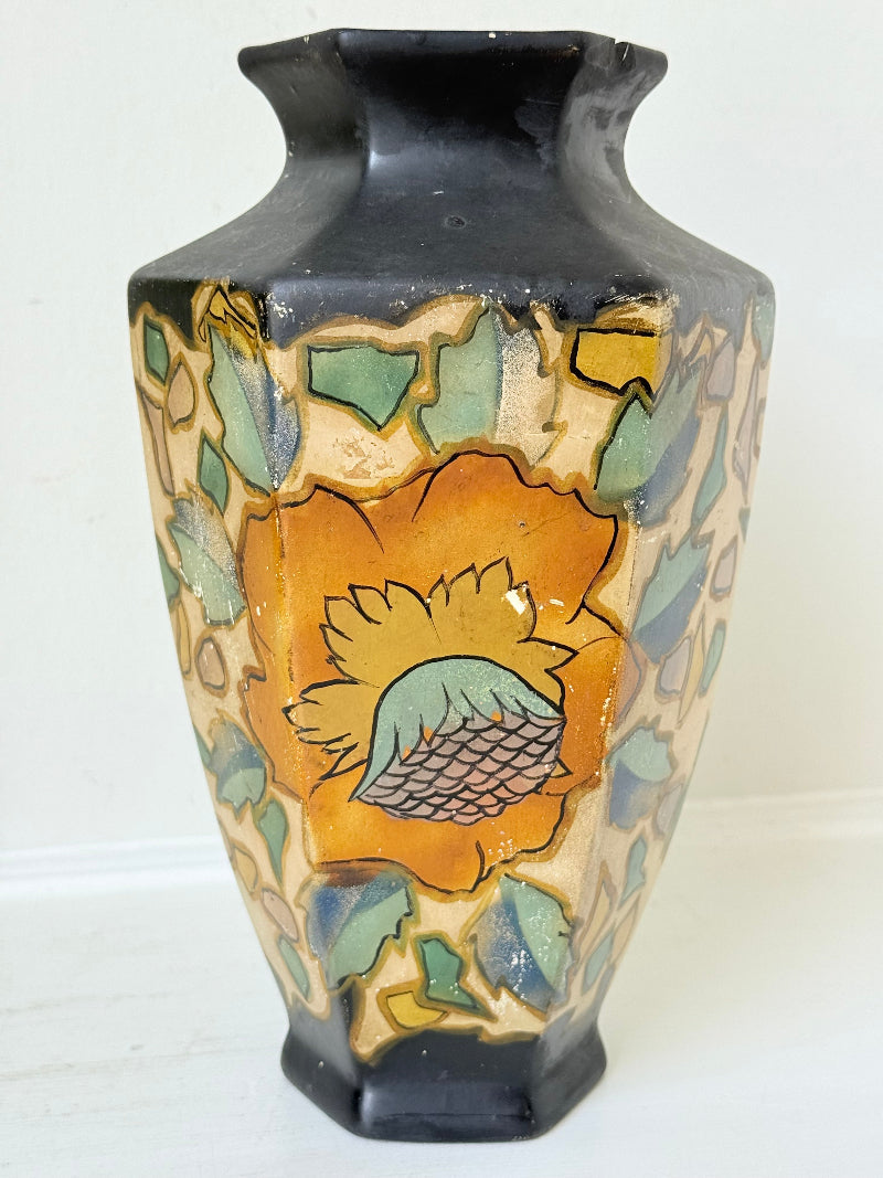 Art Deco Brentleigh Ware vase with hand painted floral design in orange, yellow, and teal on a black ground, photographed on a white surface