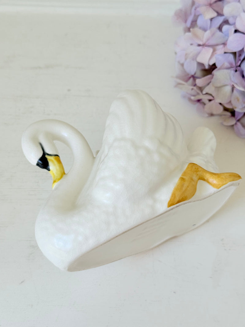Vintage Sylvac swan planter in white ceramic with yellow beak and feet, styled on a white surface