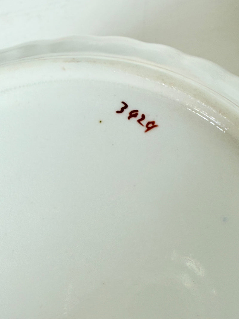 vintage porcelain sugar bowl with coral transfer design and gilt rim on white surface