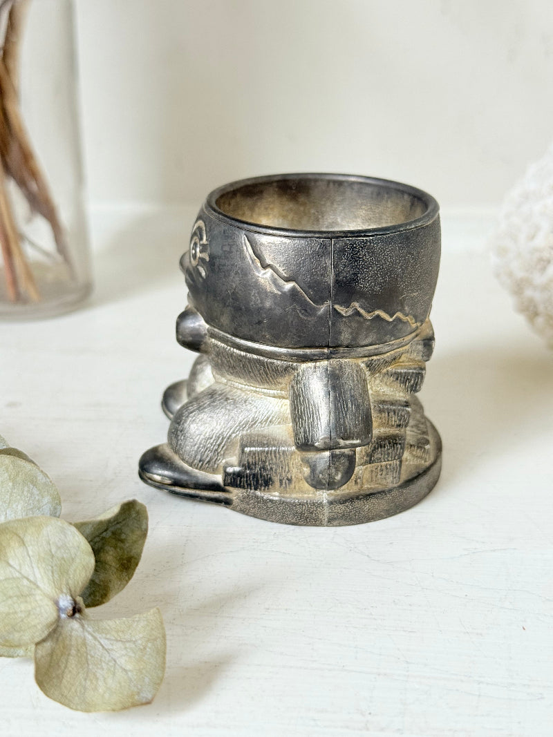 Vintage Humpty Dumpty silver plate egg cup, photographed on a white surface