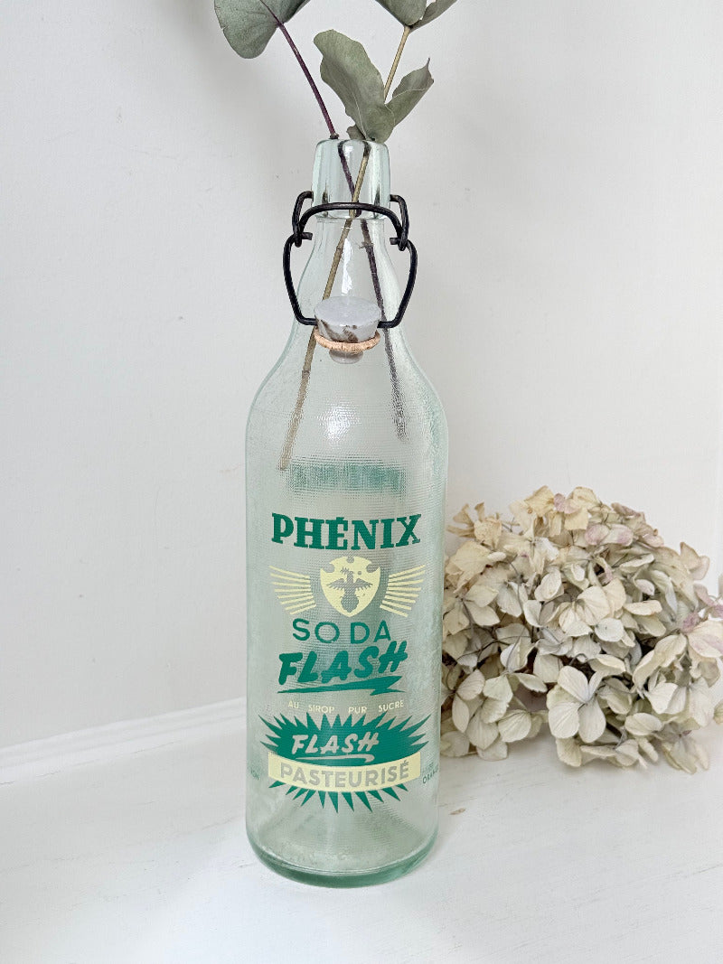 vintage french soda bottle phenix aqua green glass with ceramic swing top 31cm on white surface