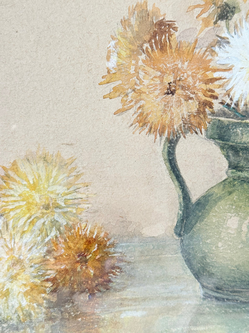 Vintage watercolour of chrysanthemums in green vase, under glass, in cream faux bamboo frame, photographed on white surface.