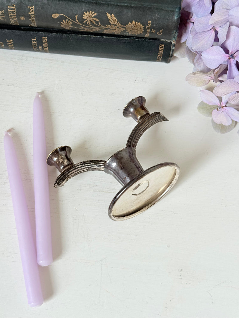 Vintage miniature silver plate candlestick with twin holders, photographed on white surface