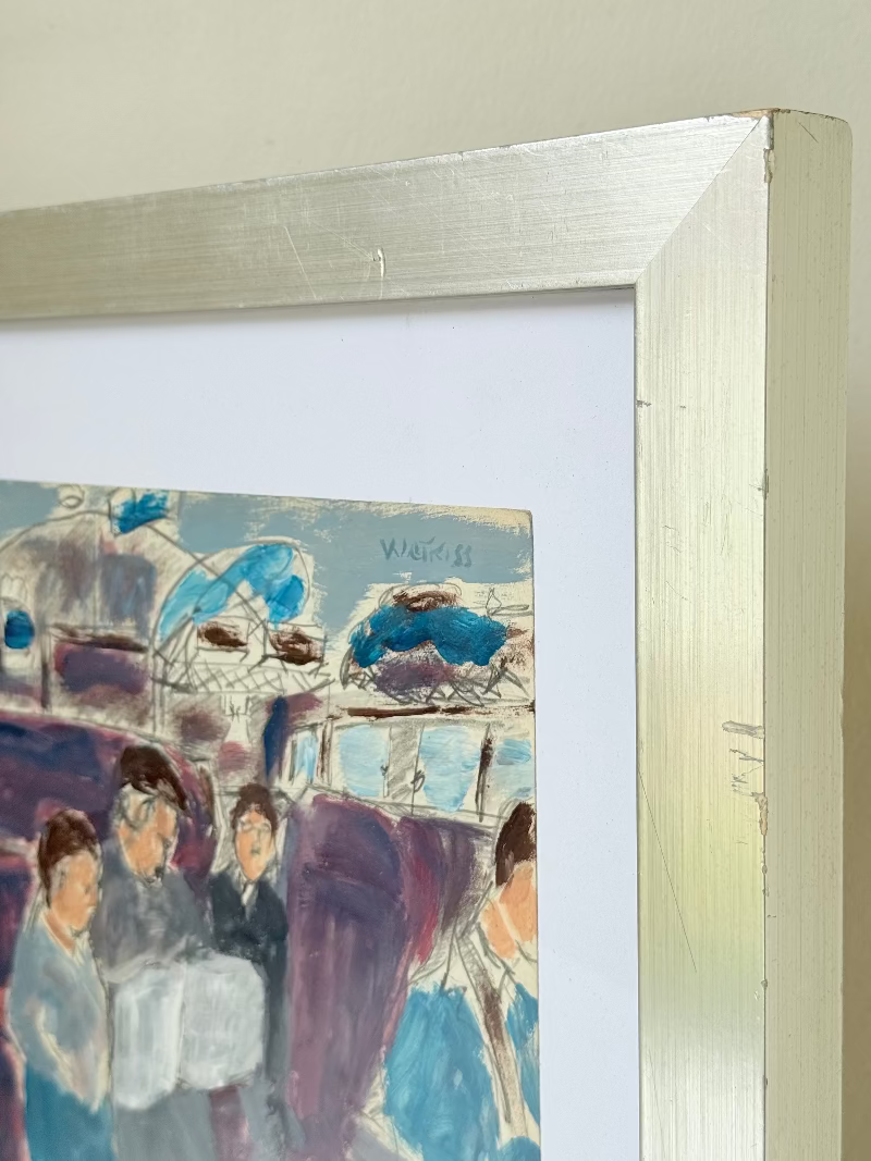 Mixed media painting by Watkiss of figures in a train carriage, framed in white, photographed on a white surface