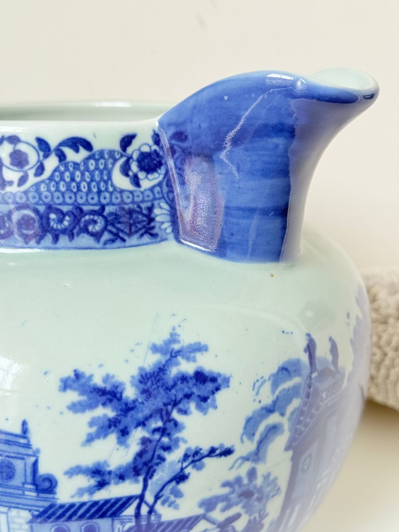 Vintage large ironstone jug with blue and white transferware decoration, photographed on a white surface