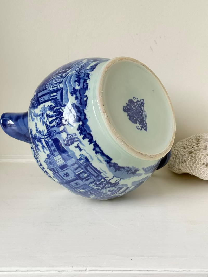 Vintage large ironstone jug with blue and white transferware decoration, photographed on a white surface
