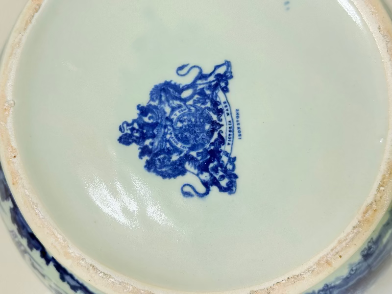 Vintage large ironstone jug with blue and white transferware decoration, photographed on a white surface