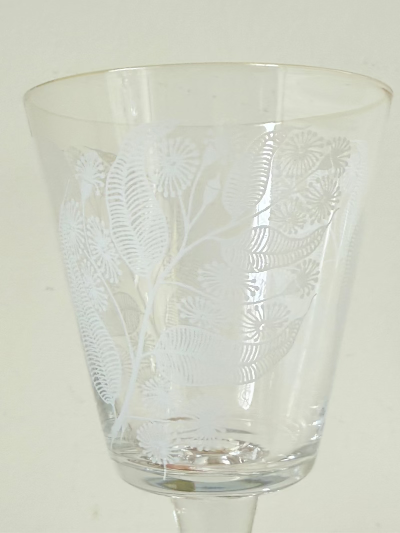 Set of six vintage wine glasses with white floral printed design, photographed on white surface.