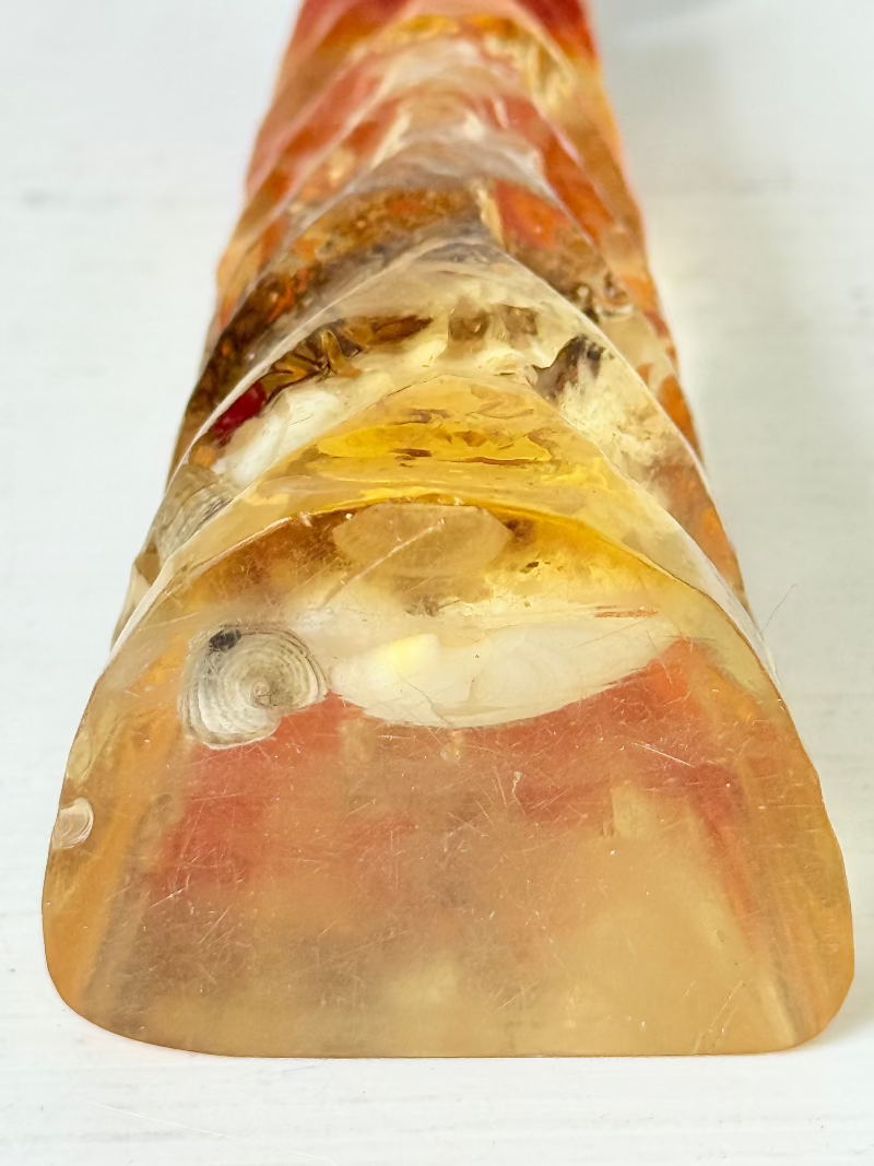 vintage 1970s resin bottle opener with embedded seashells and coastal treasures on white surface