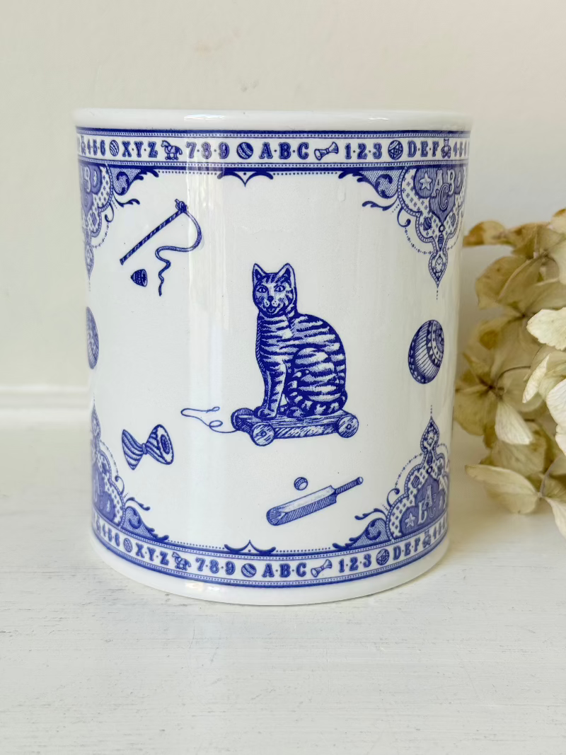 blue and white spode moneybox with sporting scene design, photographed on white surface