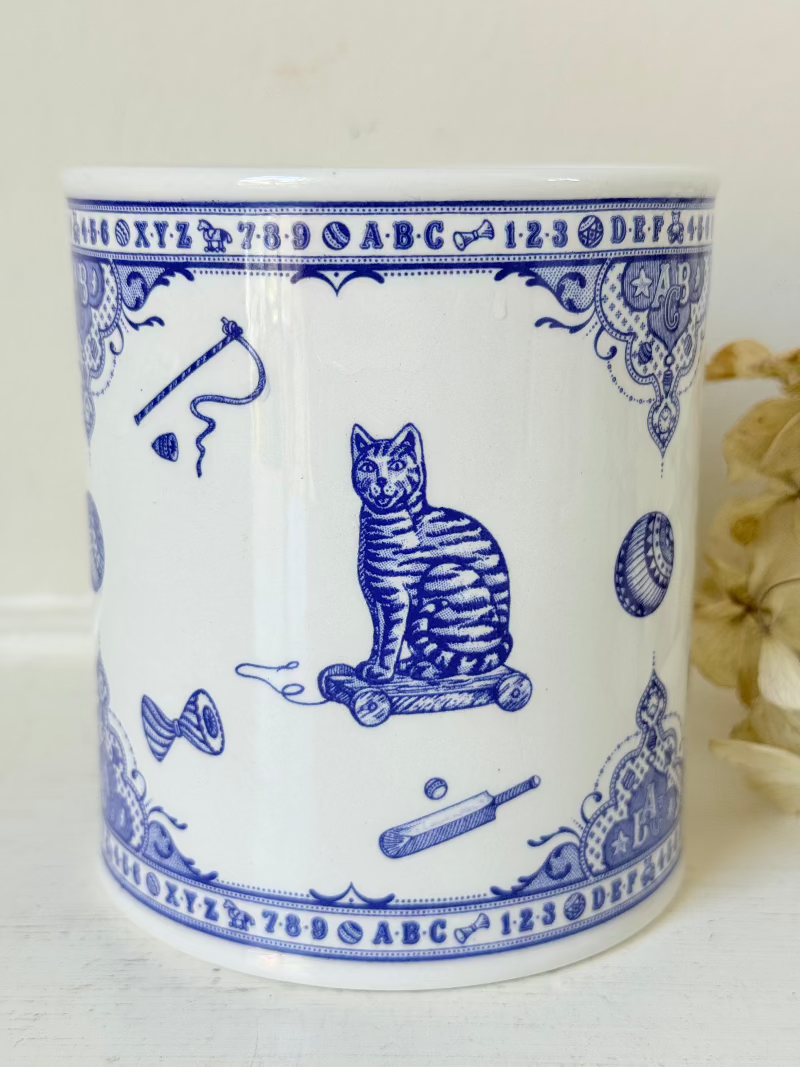 blue and white spode moneybox with sporting scene design, photographed on white surface