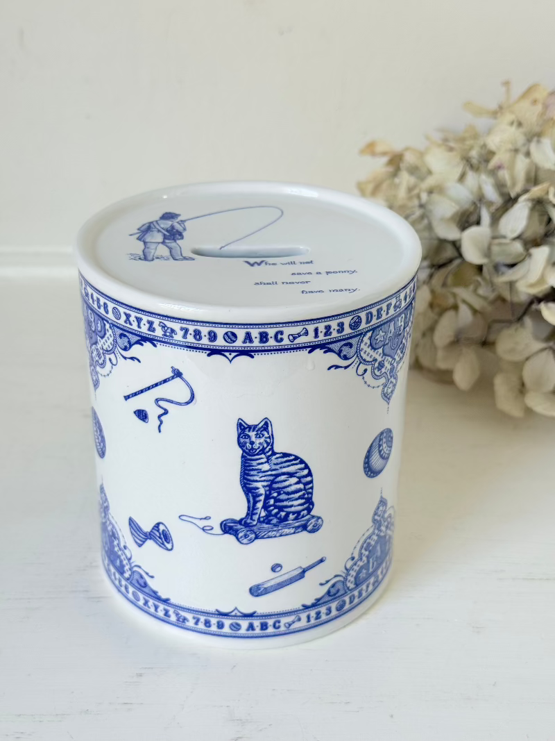 blue and white spode moneybox with sporting scene design, photographed on white surface