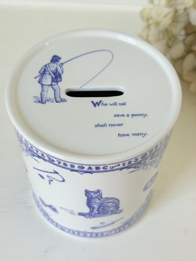 blue and white spode moneybox with sporting scene design, photographed on white surface