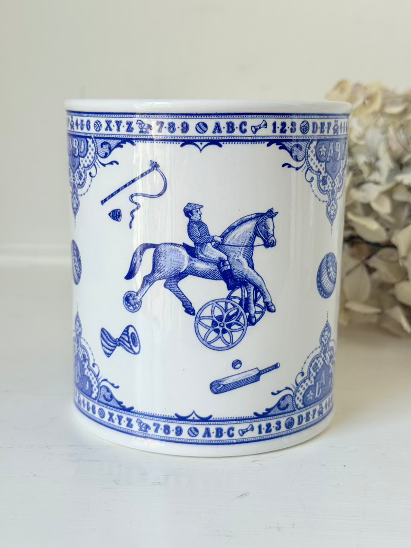 blue and white spode moneybox with sporting scene design, photographed on white surface
