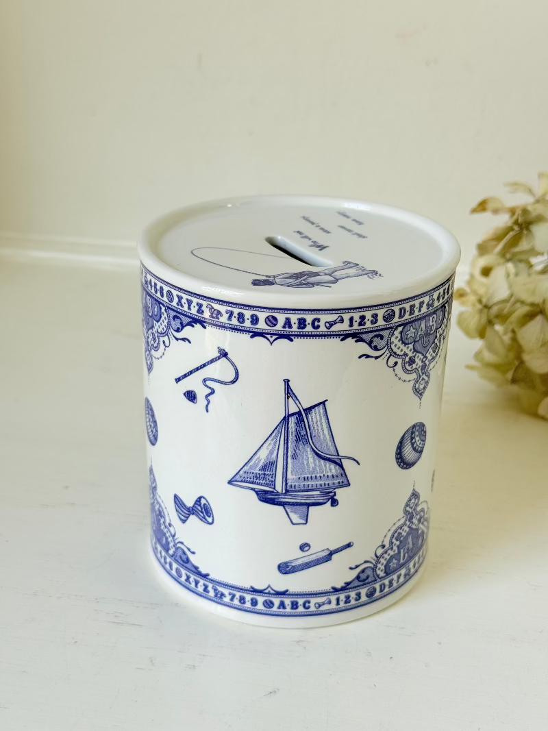 blue and white spode moneybox with sporting scene design, photographed on white surface