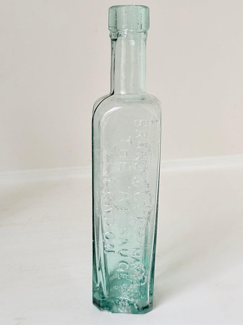 Trio of Antique Aqua Glass Bottles with Embossed Lettering