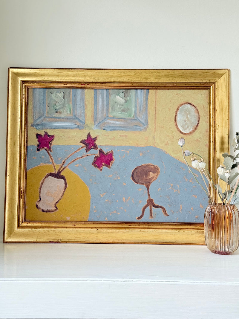 Naïve interior oil painting with red flowers in a vase, in golden frame, styled on a white dresser with neutral background