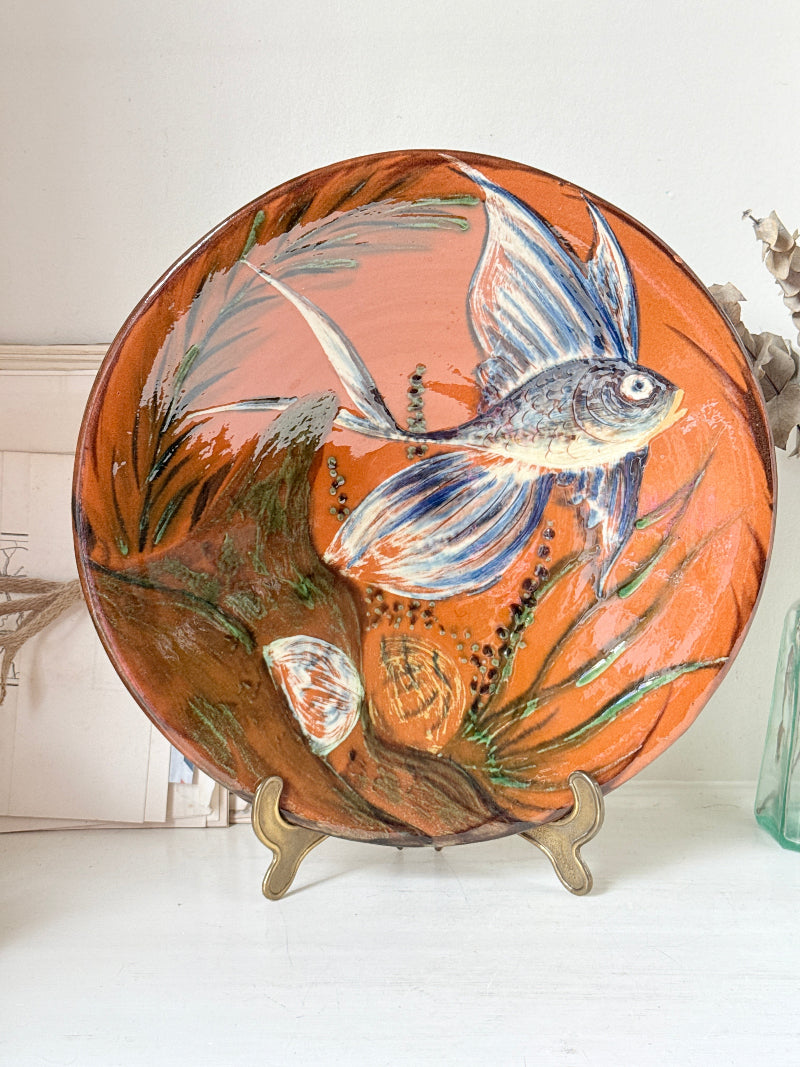 Mid century Puigdemont La Bisbal charger with hand painted fish in blue and white on orange glaze
