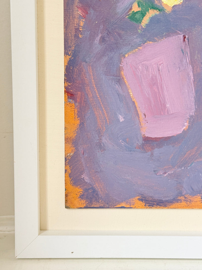 Close-up of a framed abstract painting showing textured brushstrokes in lavender, dusty pink, orange, and touches of green and yellow, with a white frame and cream mat.