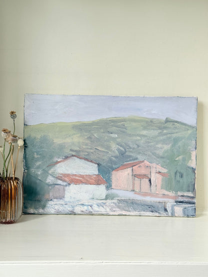 Unframed vintage oil painting of hillside cottages with terracotta roofs, green landscape, and textured brushwork, on white surface.