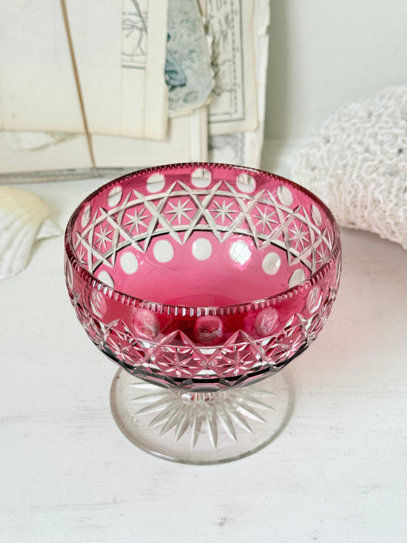 Antique cranberry cut to clear glass pedestal bowl with star and diamond pattern, clear foot and rich pink glass