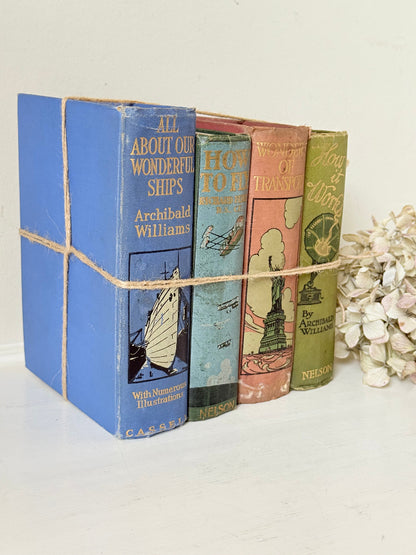 Vintage decorative book bundle in green, blue, and coral with printed lettering, tied with twine, photographed on a white surface