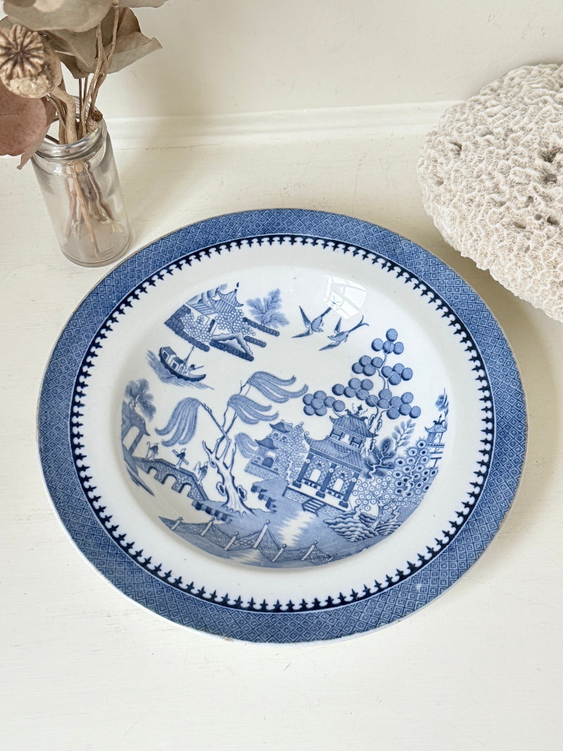 Minton Blue Willow serving dish dated 1928 with blue transfer pattern shown on a white surface.