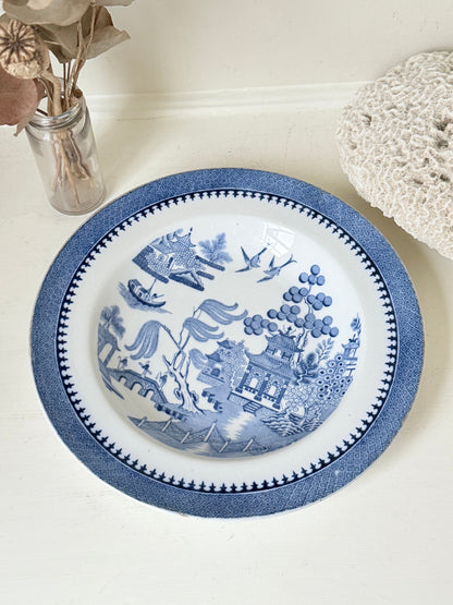 Minton Blue Willow serving dish dated 1928 with blue transfer pattern shown on a white surface.