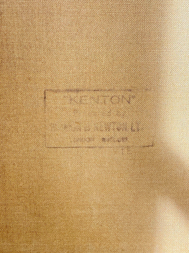 Close-up of a tan woven fabric surface with a faint stamped or printed label reading "KENTON" and smaller text below, plus a soft shadow across the right side.