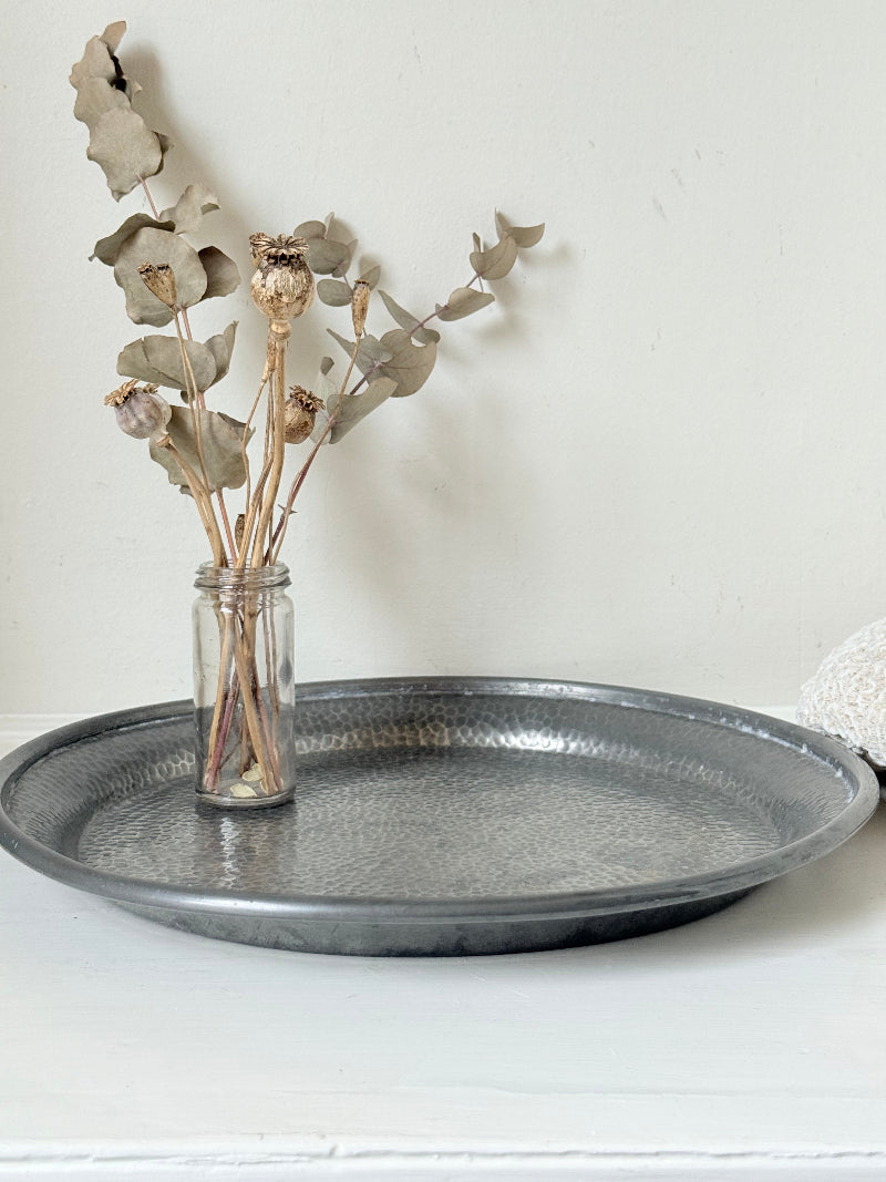 Vintage Harrods pewter drinks tray with hammered surface photographed on a white background.