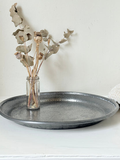 Vintage Harrods pewter drinks tray with hammered surface photographed on a white background.