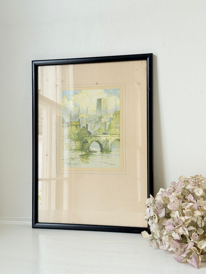 framed print of durham cathedral and elvet bridge with soft green and yellow tones photographed on white surface