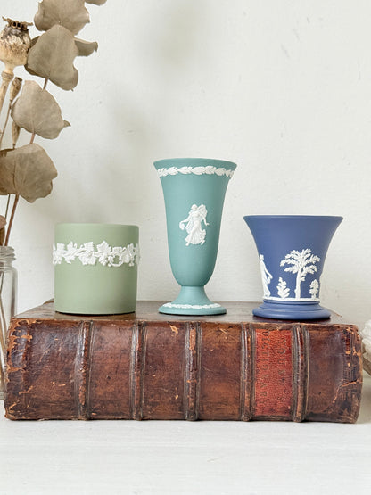 Trio of vintage Wedgwood Jasperware vases in green and blue with white relief decoration, photographed on a white surface