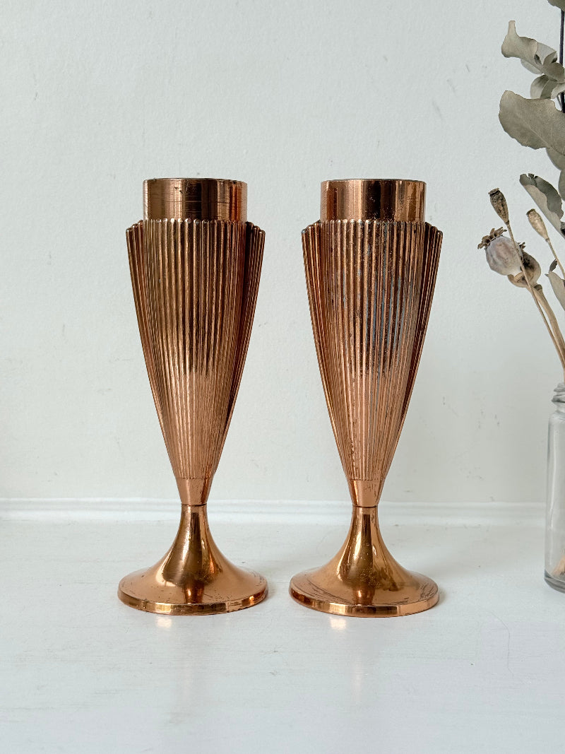 Pair of vintage copper Art Deco vases with fluted surface, photographed on a white background.