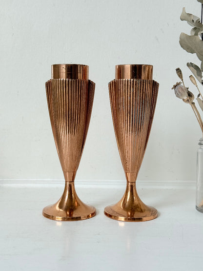 Pair of vintage copper Art Deco vases with fluted surface, photographed on a white background.