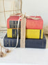 Vintage decorative book bundle in blue yellow and red with aged hardback covers tied with natural ribbon for bookshelf styling