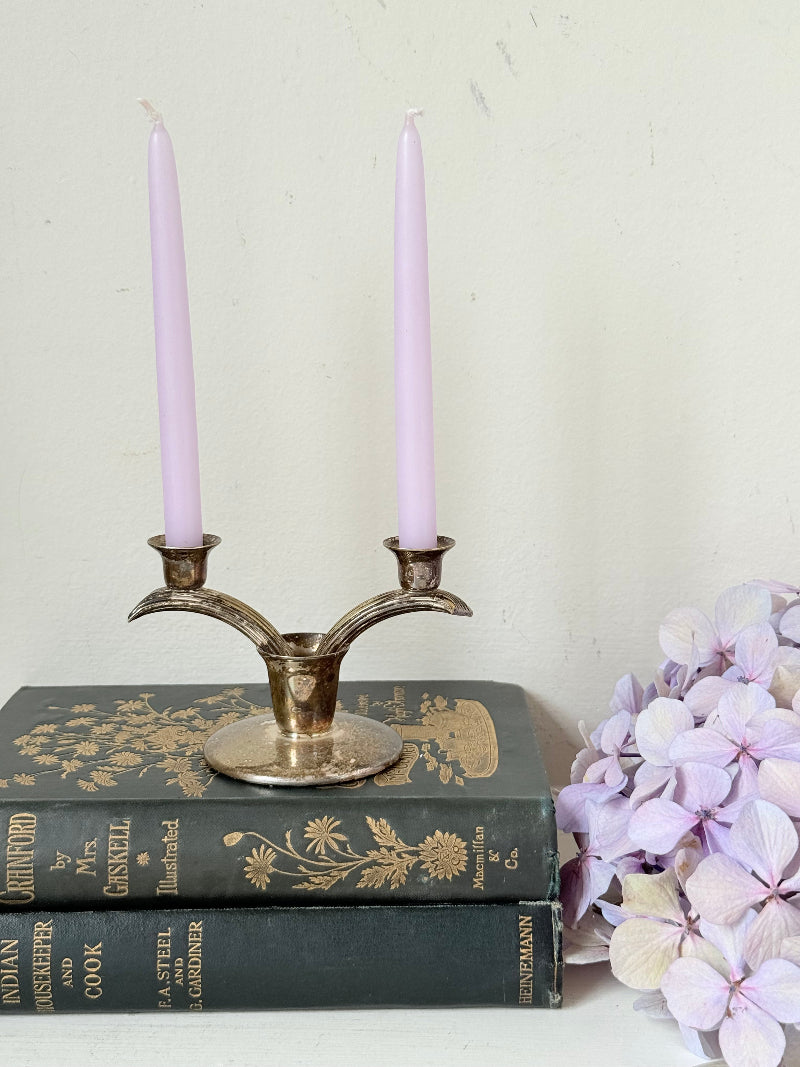 Vintage miniature silver plate candlestick with twin holders, photographed on white surface