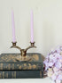 Vintage miniature silver plate candlestick with twin holders, photographed on white surface