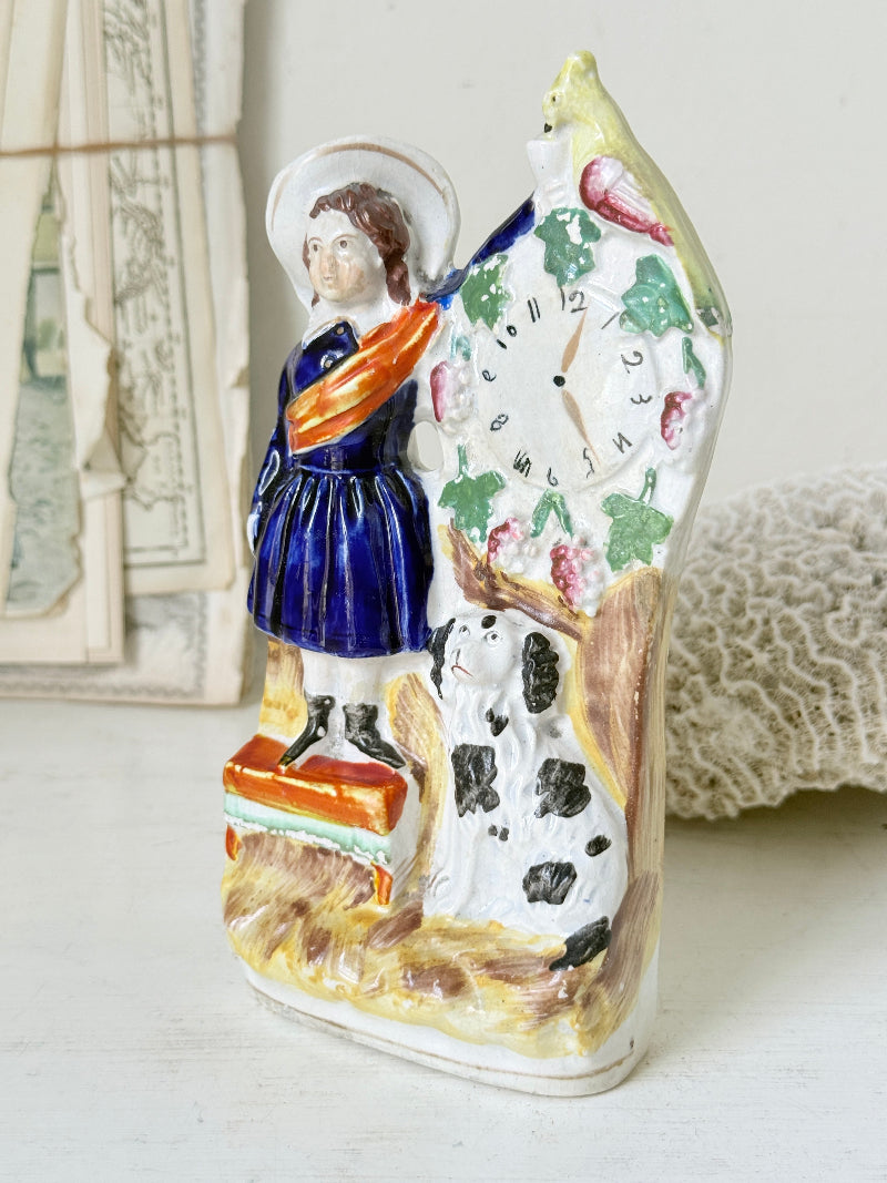 Victorian Staffordshire flatback clock group with girl spaniel and parrot hand painted in cobalt blue and orange