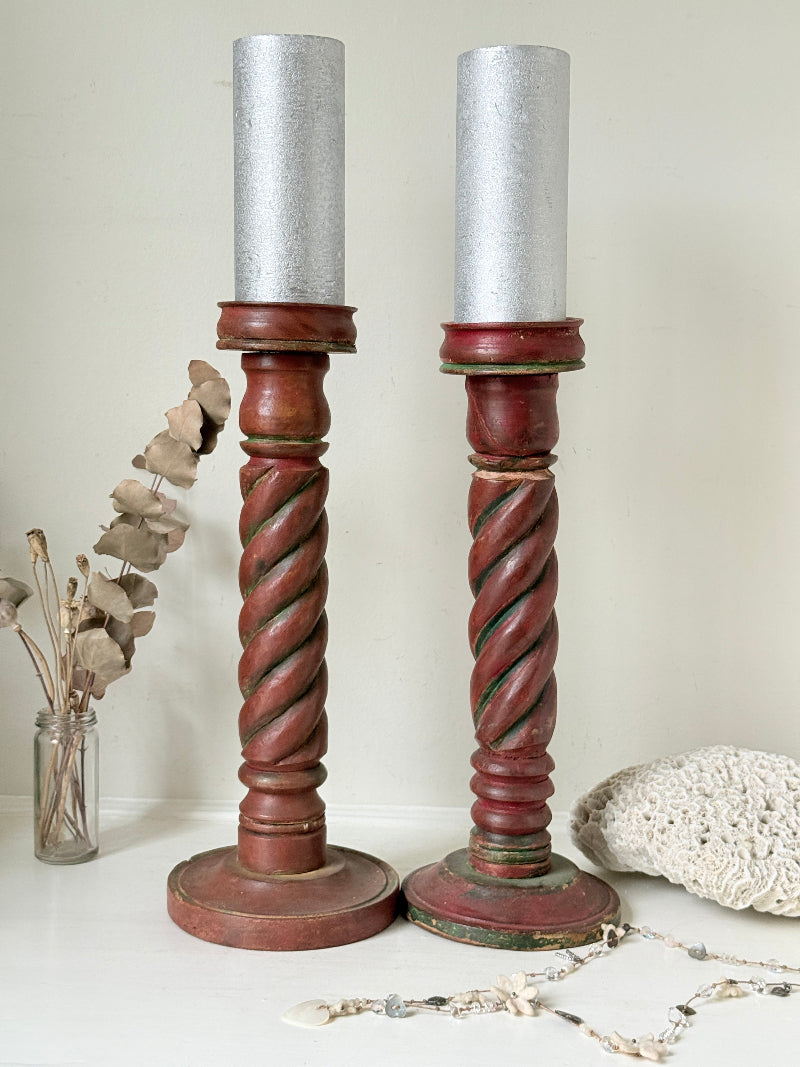 Vintage wooden barley twist candlesticks, a pair with painted finish, photographed on a white surface