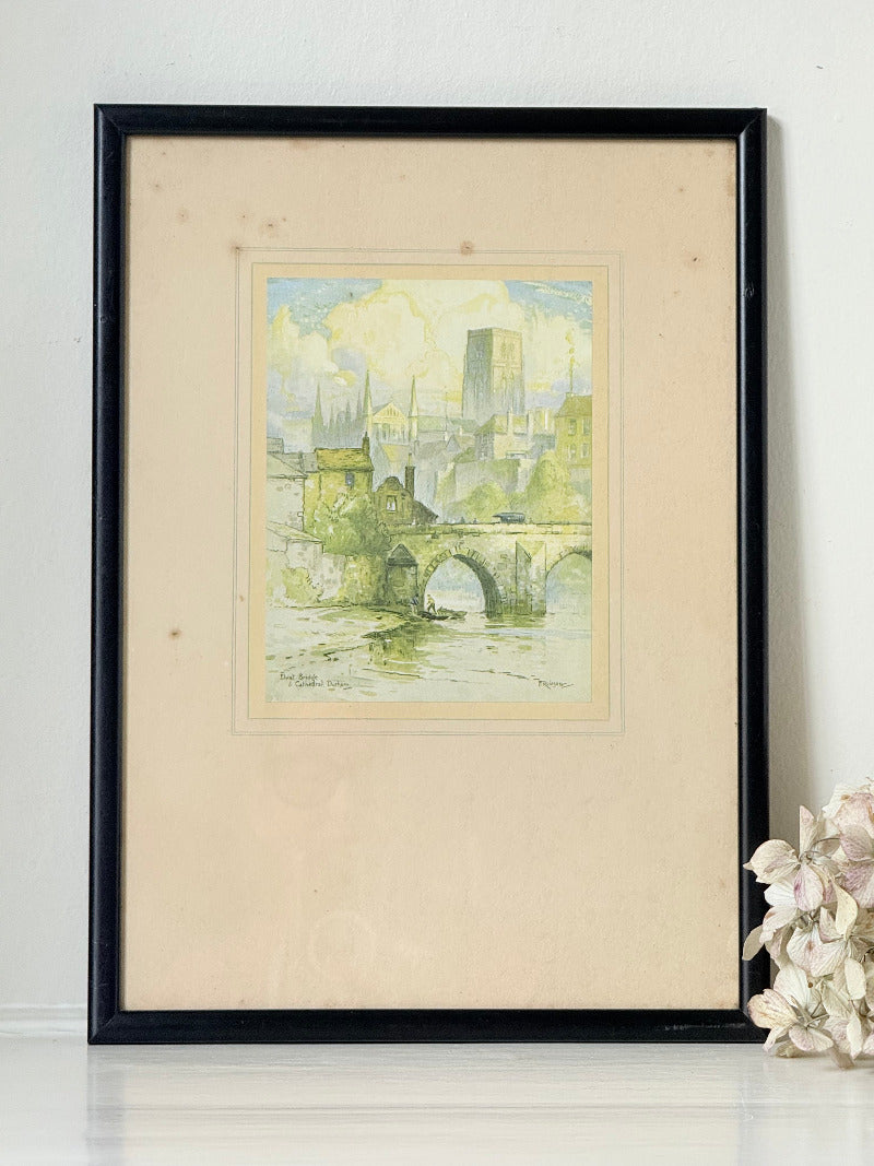 framed print of durham cathedral and elvet bridge with soft green and yellow tones photographed on white surface