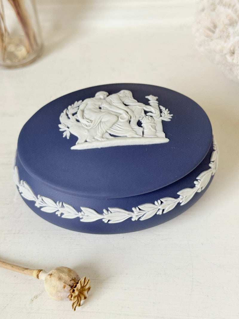 Vintage Wedgwood Jasperware Portland blue round lidded trinket box, decorated with a white neoclassical cameo and laurel wreath border.